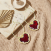 Грайливі золотисті сережки-кільця з червоним емальованим серцем та кристалом